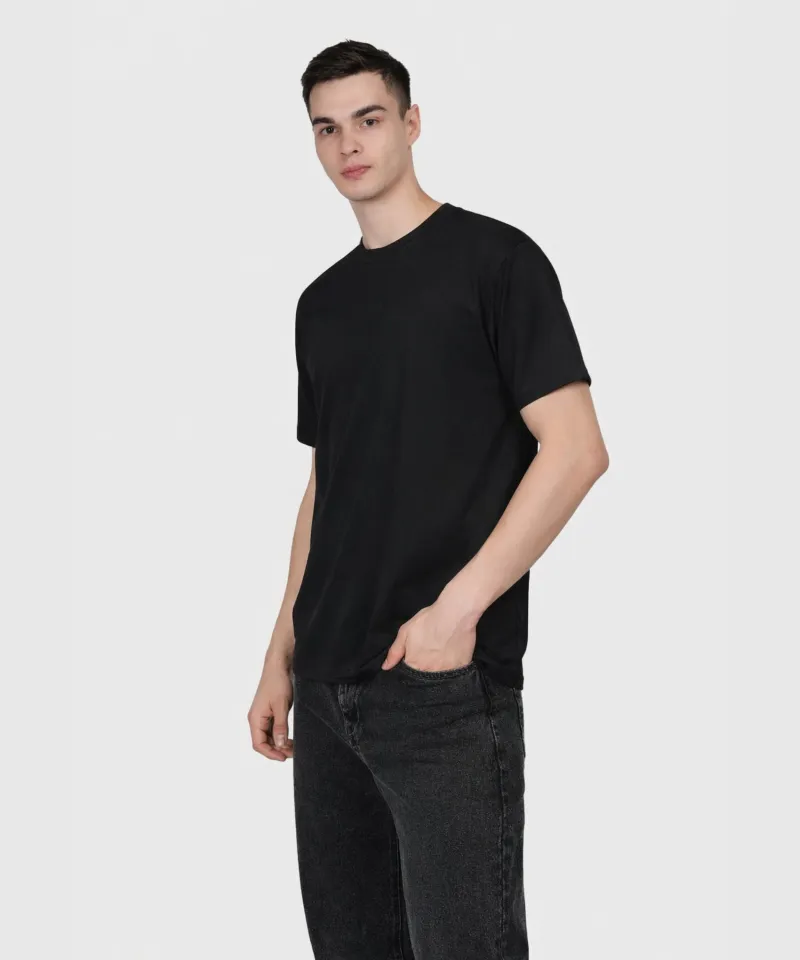 Model wearing a Gabha Enterprise black heavyweight cotton t-shirt with dark denim